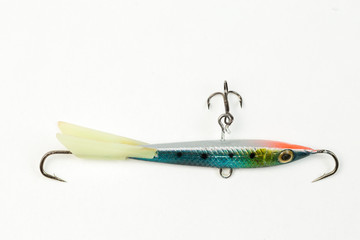 Fishing spinners and wobblers multi-colored on a background of artificial green grass. 