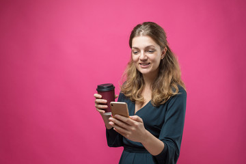 Glamor woman with a drink of coffee on a pink background	
