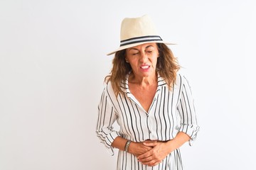 Middle age businesswoman wearing striped dress and hat over isolated white background with hand on stomach because indigestion, painful illness feeling unwell. Ache concept.