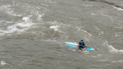 Naklejka premium Man on Kayak in wetsuit on kayak on the river