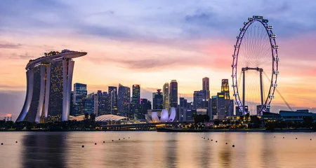 Fototapete Helix-Brücke Atemberaubende Aussicht auf die Skyline von Marina Bay mit wunderschön beleuchteten Wolkenkratzern bei einem atemberaubenden Sonnenuntergang in Singapur. Singapur ist ein Insel-Stadtstaat im Süden Malaysias.