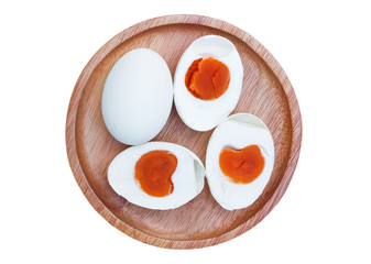 Top view of preserved duck egg (salted egg) in woodel dish isolated on white background with clipping path..