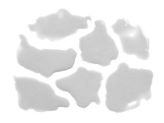 Spilled milk puddle isolated on white background. Texture of spilled milk. Milk on white background.