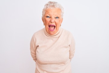 Senior grey-haired woman wearing turtleneck sweater standing over isolated white background angry...
