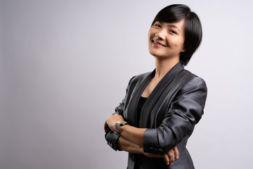 Portrait of a confident woman standing isolated over background