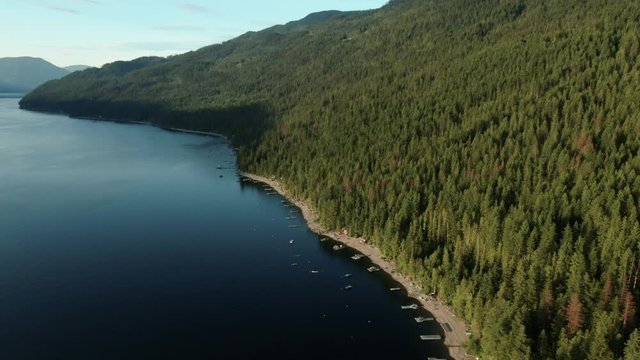 Aerial Drone Shot of Shuswap Lake Beach Front with Cabin Docks and Boats in Summer British Columbia Canda Vacation Hotspot