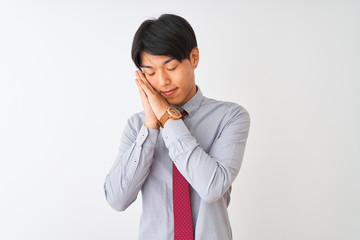 Fototapeta premium Chinese businessman wearing elegant tie standing over isolated white background sleeping tired dreaming and posing with hands together while smiling with closed eyes.