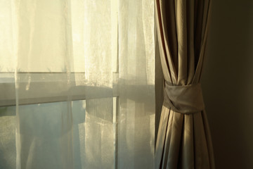 sunlight in morning day through white curtain on window