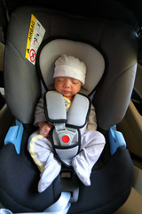 cute newborn baby sleeping in car seat safety belt lock protection drive road trip