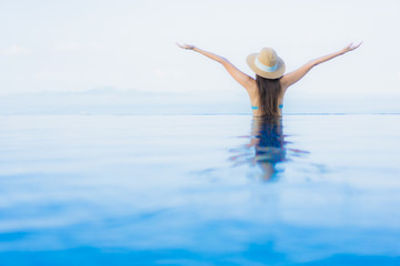 Fototapeta premium Portrait beautiful young asian women happy smile relax outdoor swimming pool in resort