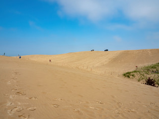 Fototapeta na wymiar trucks on the sand dunes