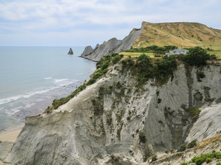 Fototapeta na wymiar Typical new zealand's countryside style white house builded on the edge of the cliff Cape Kidnappers Te Kauwae-a-Māui with the view to pacific ocean, Napier, Hastings, Hawke's Bay, North Island