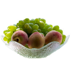 Green grape and peaches isolated on white.