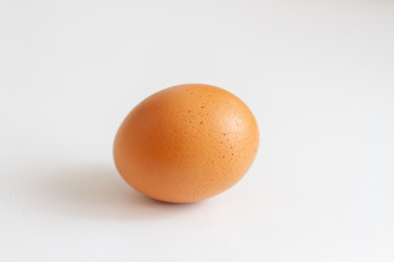 beautiful brown oval shaped chicken egg on a white background