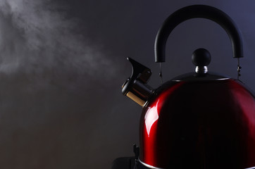 Kettle with boiling steam on a gas stove