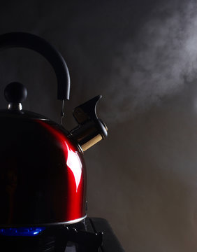 Kettle with boiling steam on a gas stove