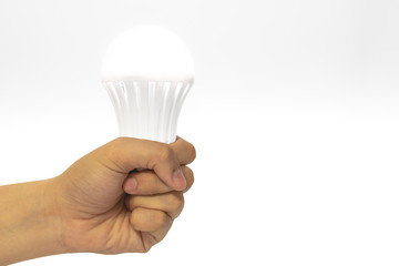 A hand holding a lightbulb. Concept of confident to success, archive in business, education and life goal target. Free copy space on right for text or design.