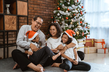 grandparents and children having fun during christmas day celebration at home with family