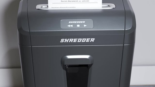 Shredding important documents. Following view at a page being shredded. 4KHD