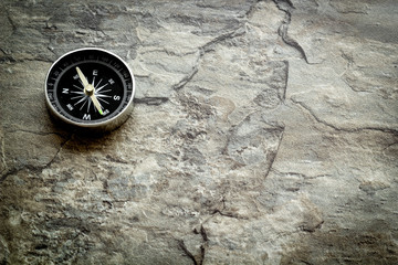 Fototapeta na wymiar Compass - small and stylish - on grey background copy space