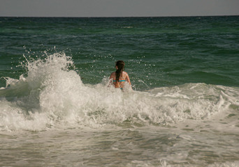 Girl Playing In Rough Surf