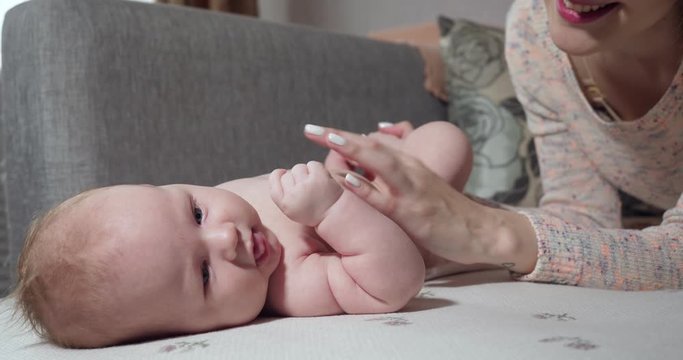 Mother communicates with her little baby girl.
