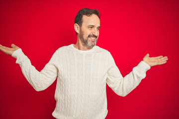 Fototapeta premium Handsome middle age senior man with grey hair over isolated red background smiling showing both hands open palms, presenting and advertising comparison and balance
