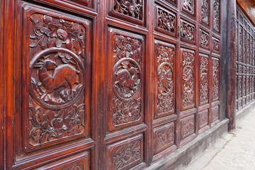 Beautiful wooden door with animal and floral carving at Lijiang, China.   