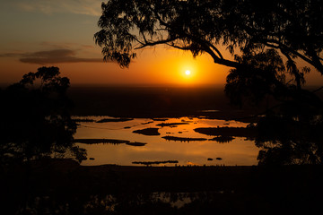 Fototapeta na wymiar Sunrise lake views through the treetops
