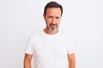 Middle age handsome man wearing casual t-shirt standing over isolated white background depressed and worry for distress, crying angry and afraid. Sad expression.