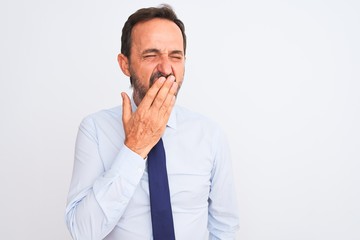 Middle age businessman wearing elegant tie standing over isolated white background bored yawning tired covering mouth with hand. Restless and sleepiness.