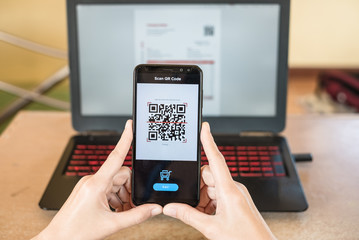 Close up of hand smartphone to make mobile wallet payment via QR code scanning digital invoice from...