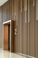 Detail of Random wooden strip wall in vertical direction at pre-function space / interior / natural light