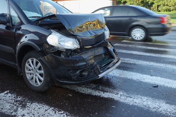 Car accident. The car crashed on crosswalk on a wet road . 