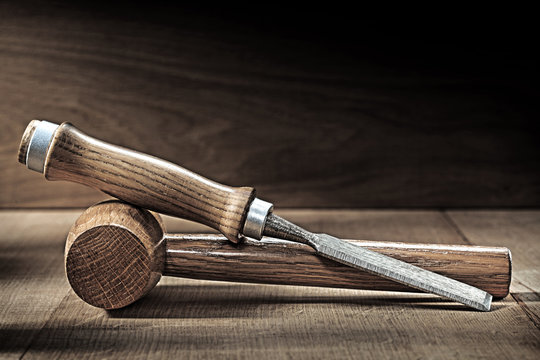 chisel and small wooden malet on vintge wood
