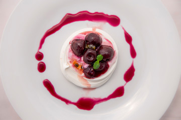 Dessert Pavlova of meringue with cherries