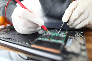 Technician soldering laptop parts
