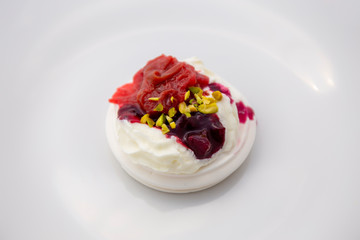 Dessert Pavlova of meringue with rhubarb and pistachio