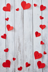 Red paper hearts on White wooden table
