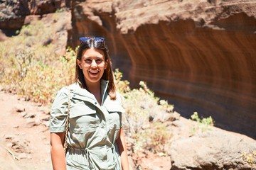 Naklejka premium Young beauitufl hiker woman trekking natural orange mountain on summer holidays