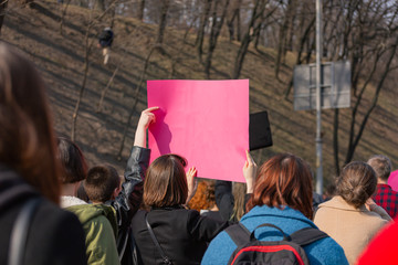 Young people at a peaceful demonstration in a modern city.