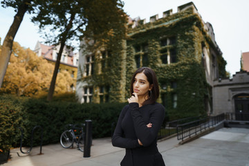 brunette girl walking through the park in Chicago during fall