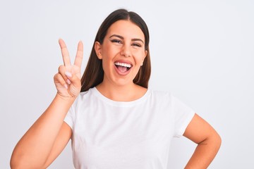 Fototapeta na wymiar Portrait of beautiful and young brunette woman standing over isolated white background showing and pointing up with fingers number two while smiling confident and happy.