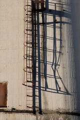 Caged ladder up side of building 