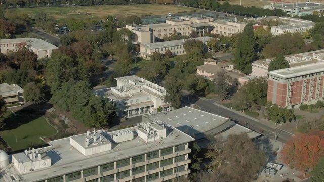Aerial: flying over UC Davis campus in Davis, California, USA. 11 November 2019.