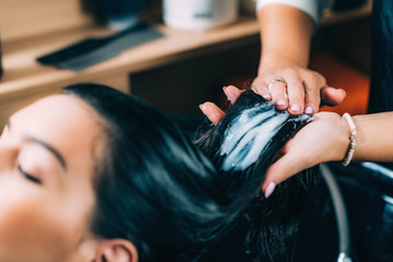 Hairdresser’s Hands Applying Conditioner