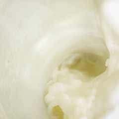 Abstract square background of pouring fresh milk