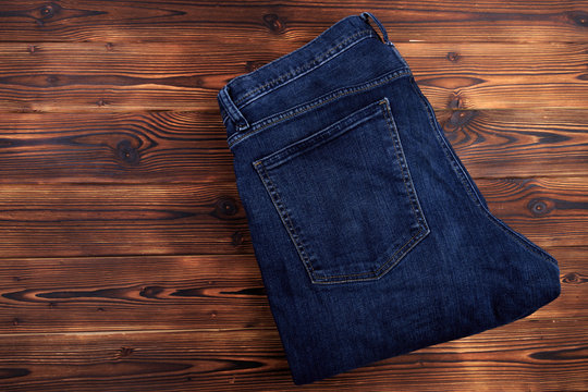 blue denim jeans  on wooden background .