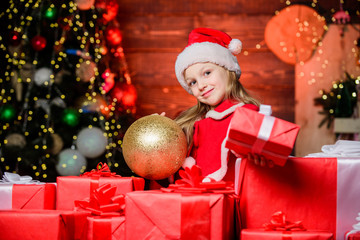 For you. Adorable santa child giving gift box. Little child celebrate Christmas and new year. Small child wearing red santa hat on boxing day. Cute girl child with Christmas present boxes from santa