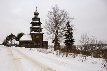 The old wooden Church is located on a hill. Winter landscape. Torzhok, Russia.